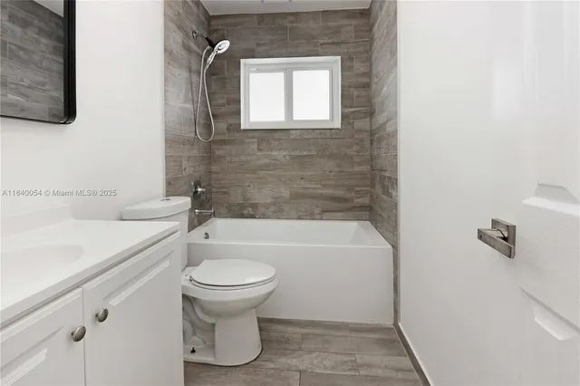 a bathroom with a sink a toilet and bathtub