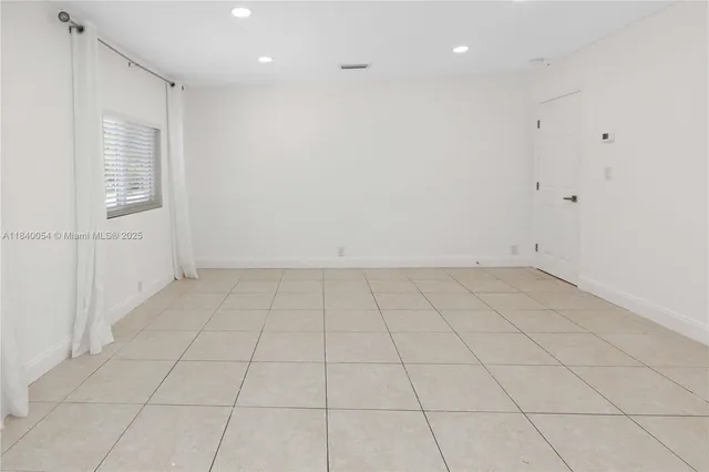 an empty room with a empty space and windows