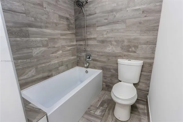 a view of a room with a ceiling fan and window