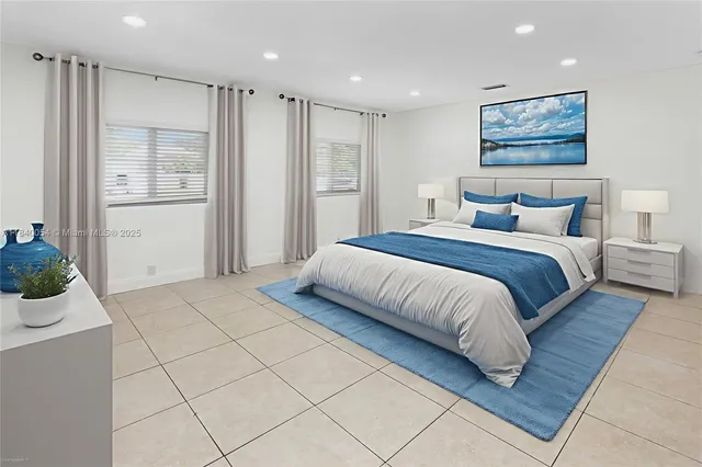 a spacious bedroom with a large bed and a painting on the wall