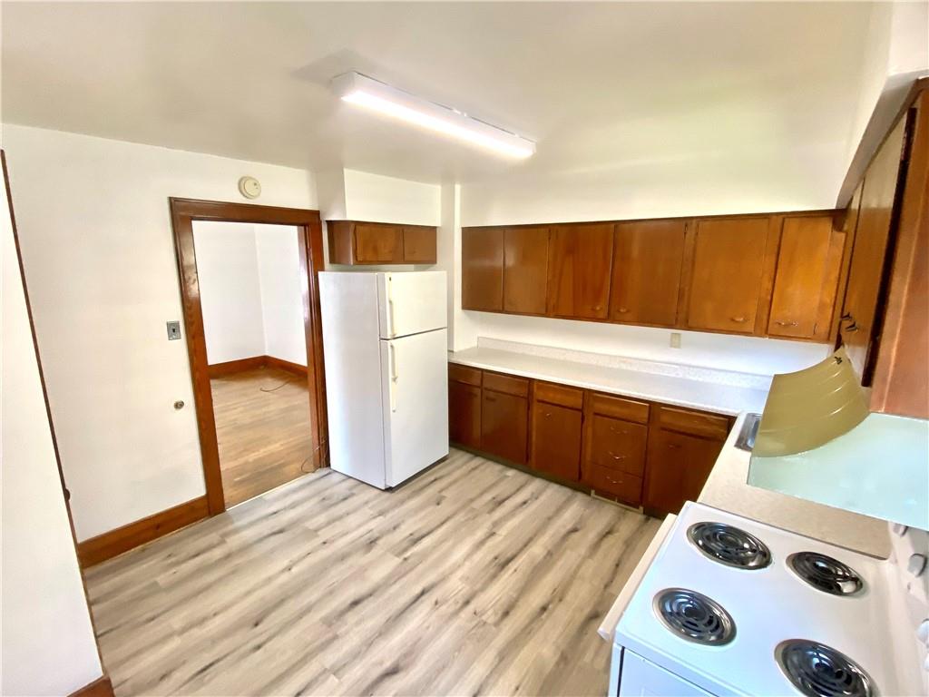 671 Washington Street Indiana, PA 15701 - Photo 6 of 20 a kitchen with a refrigerator and a wooden floor