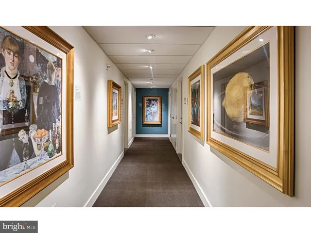 a room with gym equipment and large windows