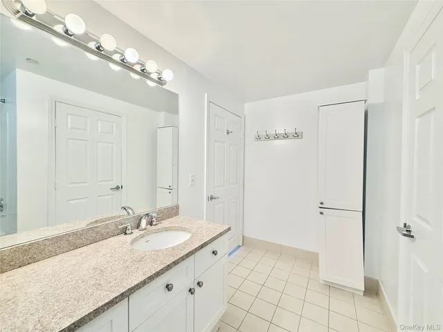 a kitchen with stainless steel appliances kitchen island hardwood floor sink stove dining table and chairs