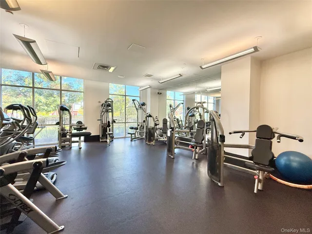 a living room with couches and projector with a flat screen tv