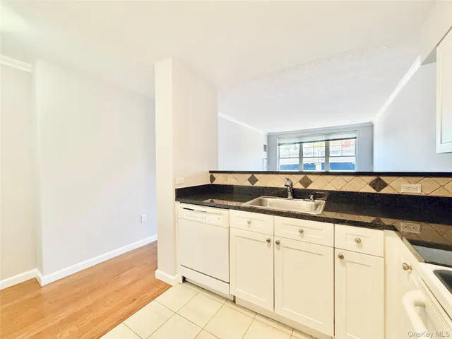 a view of a big room with wooden floor and windows