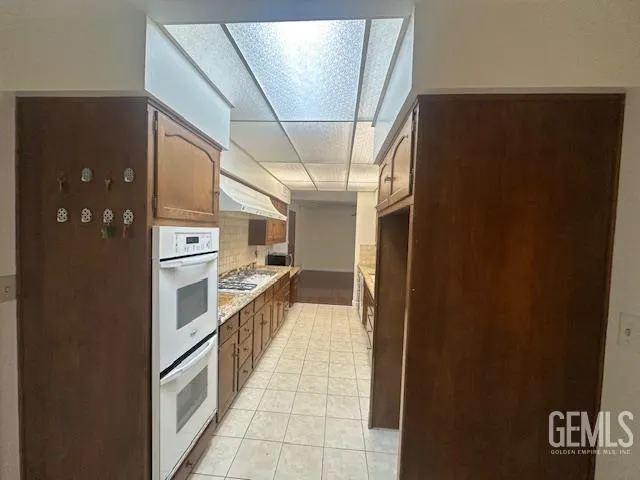 a kitchen with stainless steel appliances a refrigerator and a stove
