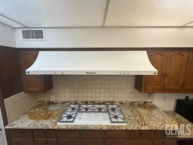 a kitchen with a sink and a stove