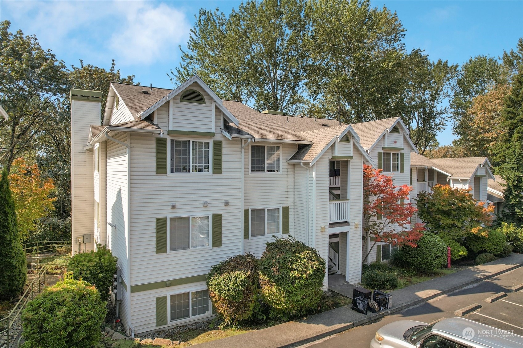 901 Sunset Boulevard Northeast, Unit D115 Renton, WA 98056 - Photo 1 of 19 a front view of a house with a yard
