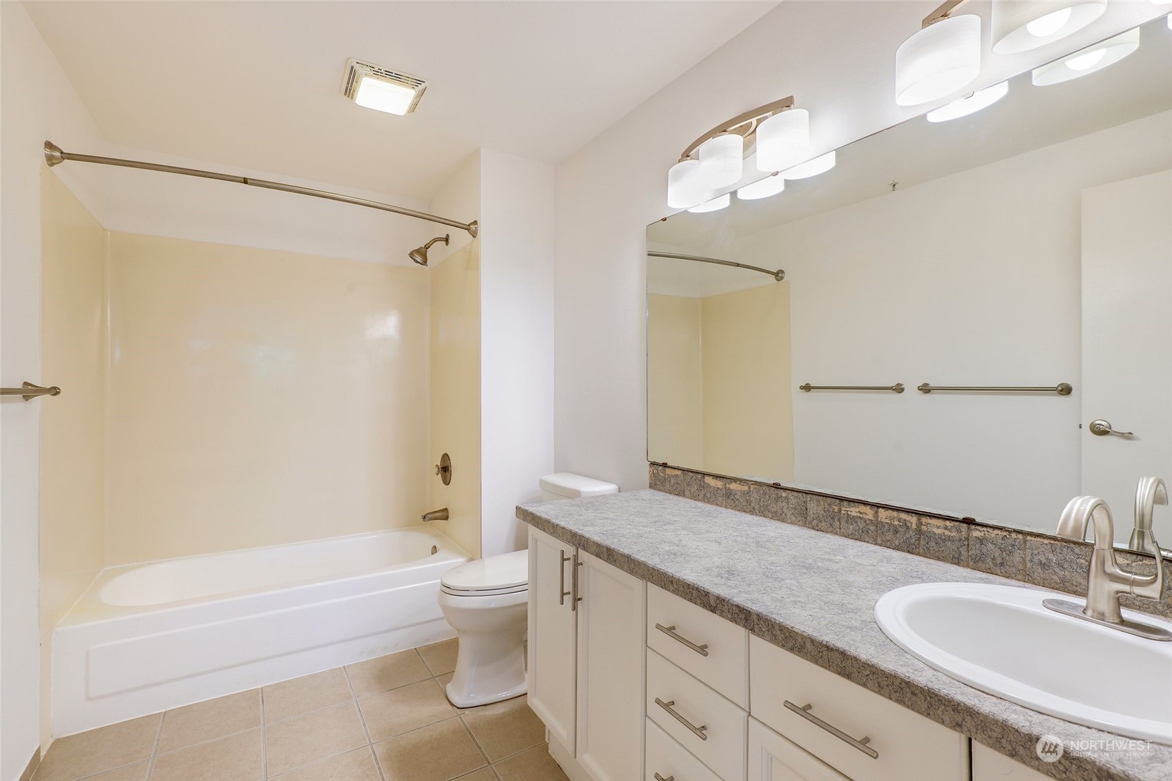 901 Sunset Boulevard Northeast, Unit D115 Renton, WA 98056 - Photo 16 of 19 a bathroom with a granite countertop sink toilet mirror and shower