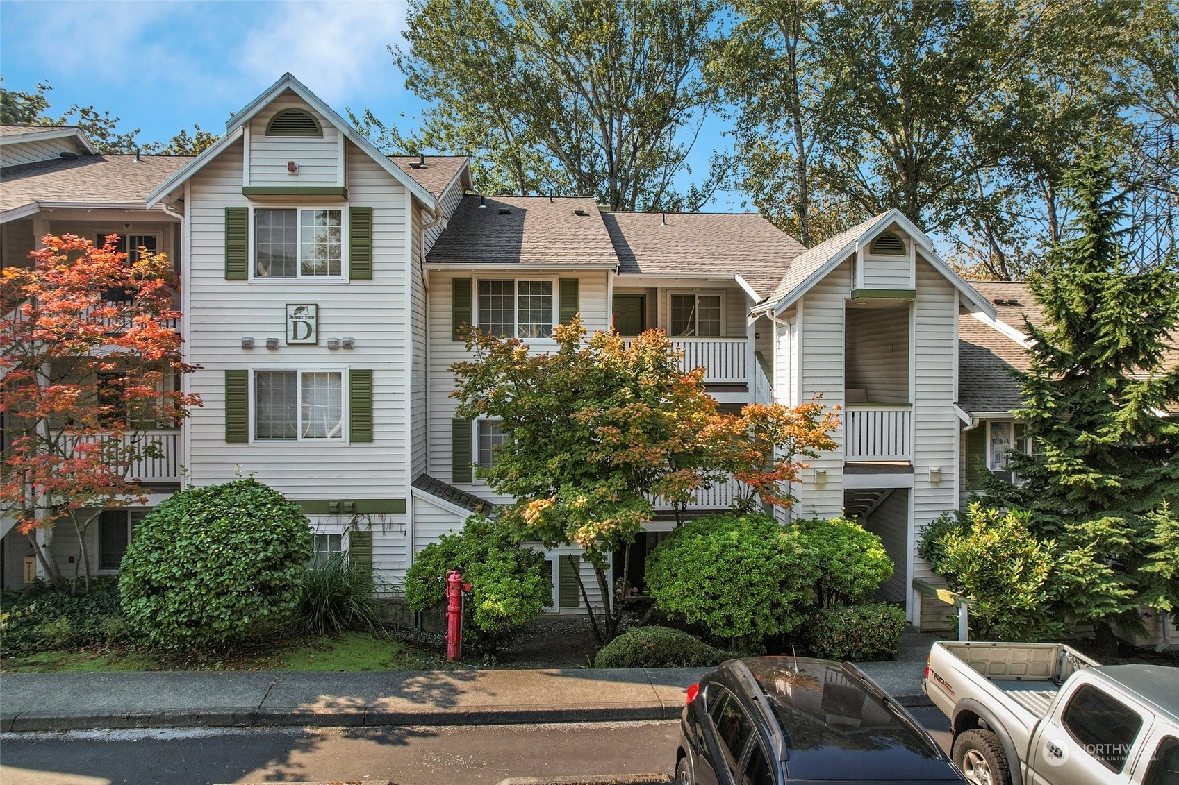 901 Sunset Boulevard Northeast, Unit D115 Renton, WA 98056 - Photo 2 of 19 a front view of a house with a yard and garage