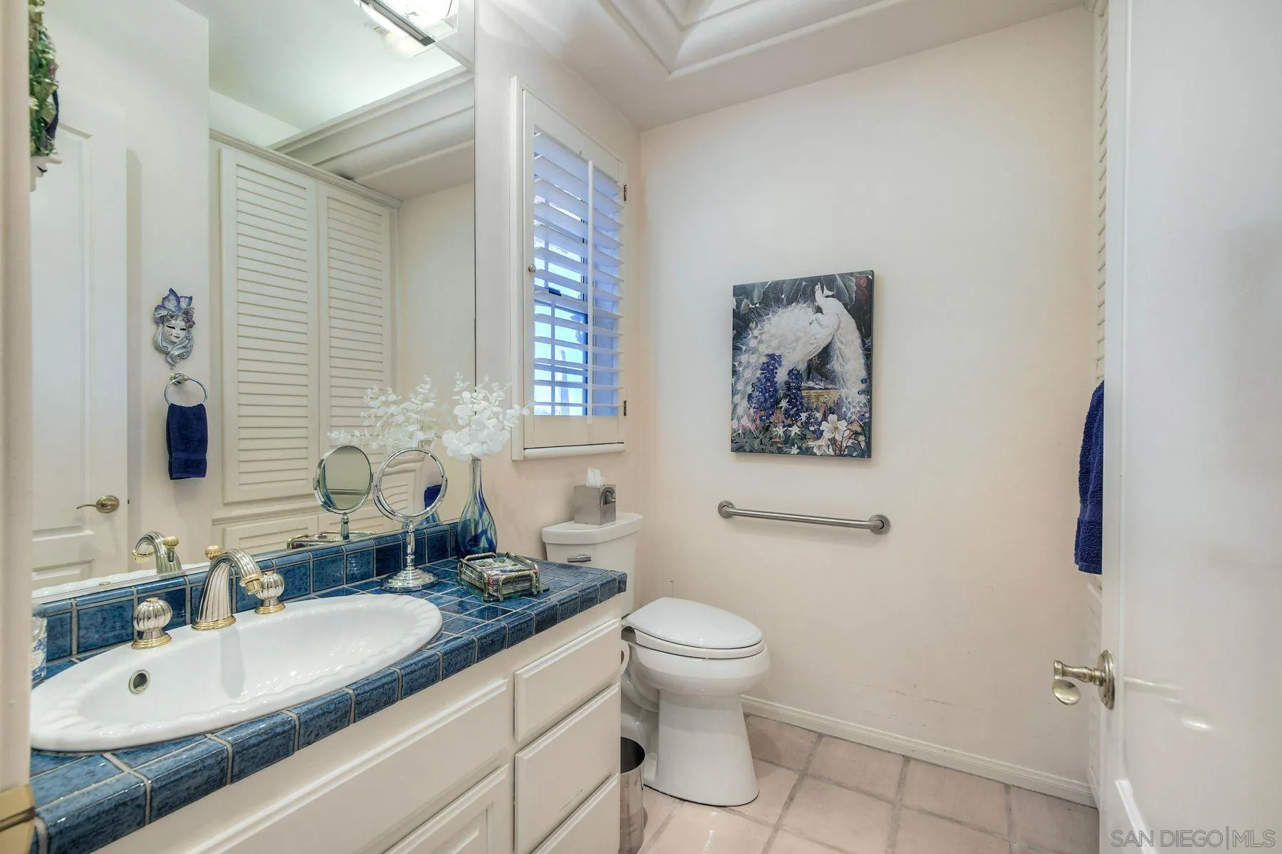 13455 Old Winery Road Poway, CA 92064 - Photo 23 of 46 a bathroom with a granite countertop sink mirror vanity and toilet
