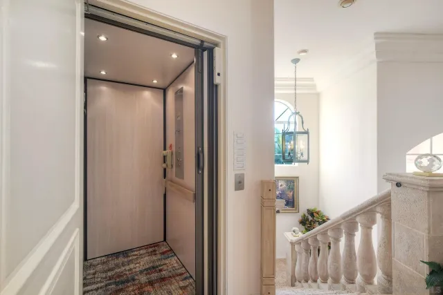 a view of a hallway with wooden floor and stairs