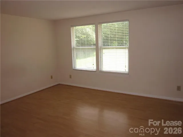 a front view of a house with a garden and yard