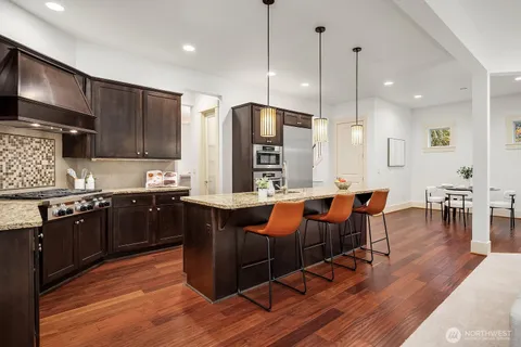a large kitchen with lots of counter space and stainless steel appliances