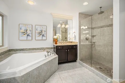 a spacious bathroom with a tub a shower and view
