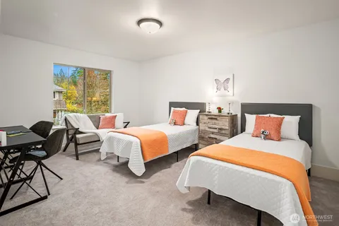 a bedroom with two beds and a couch