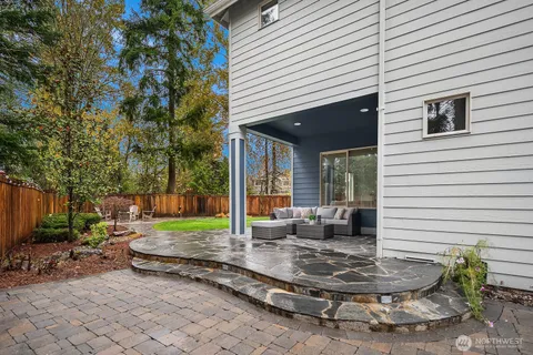 a view of a house with backyard and sitting area