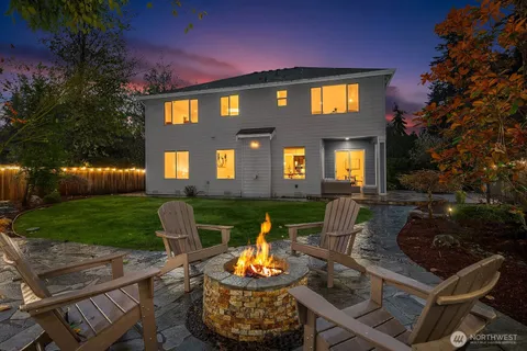a front view of a house with a yard fire pit and outdoor seating