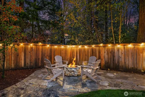 a view of a patio with table and chairs with wooden fence and plants