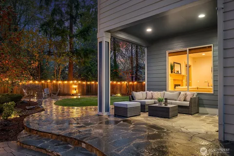 a living room with patio furniture and garden