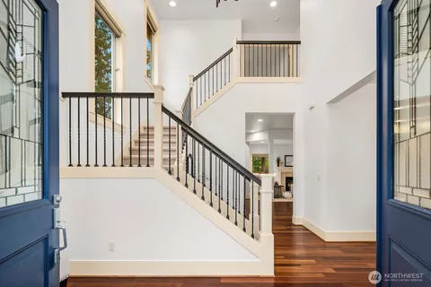 a view of an entryway with wooden floor and windows