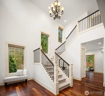 a view of entryway with wooden floor and a front door
