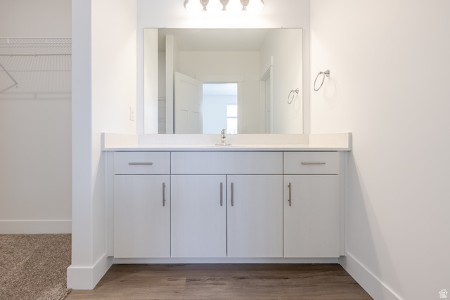 4727 South 690th West, Unit W202 Mapleton, UT 84664 - Photo 13 of 16 White vanity with a light-toned countertop and an integrated sink