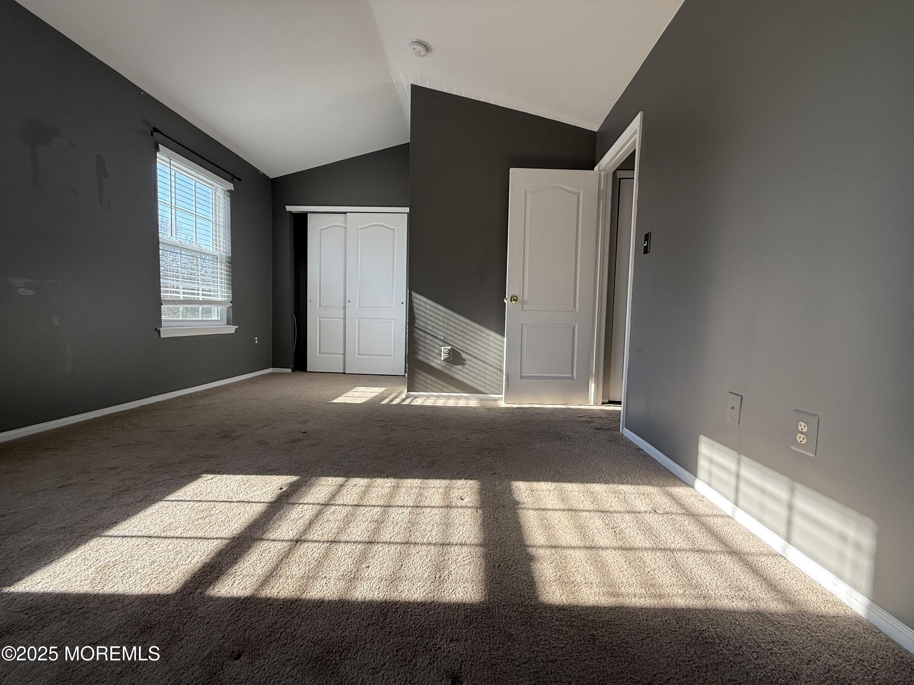 52 Aberdare Court, Unit 4 Freehold, NJ 07728 - Photo 12 of 18 a view of an empty room and window
