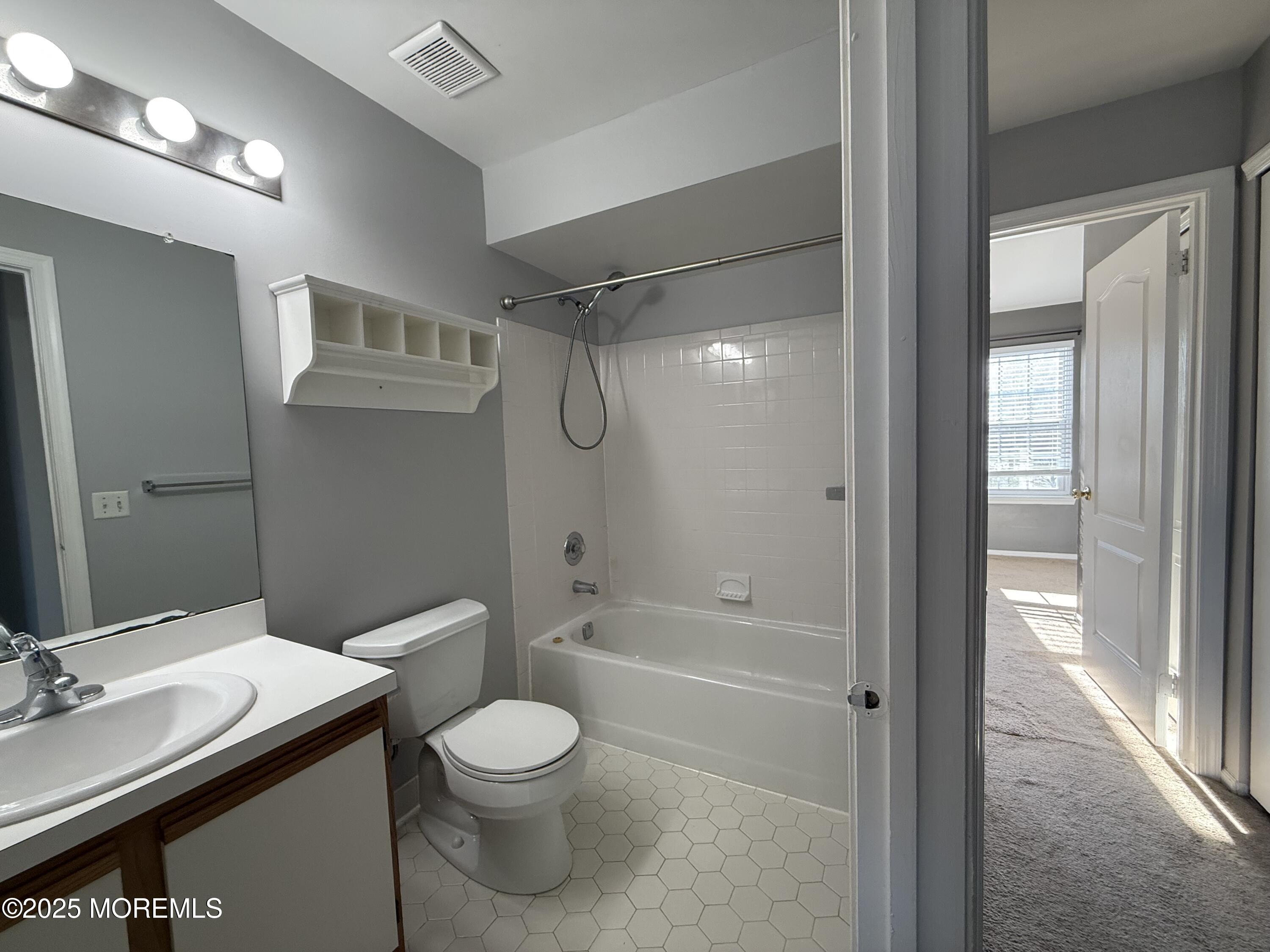 52 Aberdare Court, Unit 4 Freehold, NJ 07728 - Photo 15 of 18 a bathroom with a granite countertop sink toilet and shower
