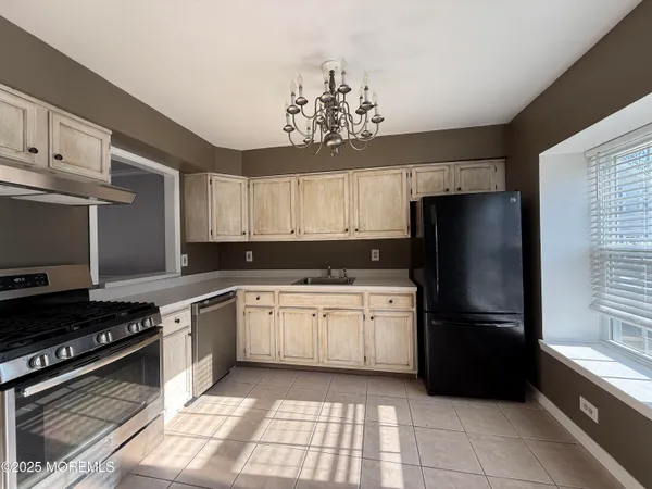 a kitchen with a refrigerator a sink and a stove
