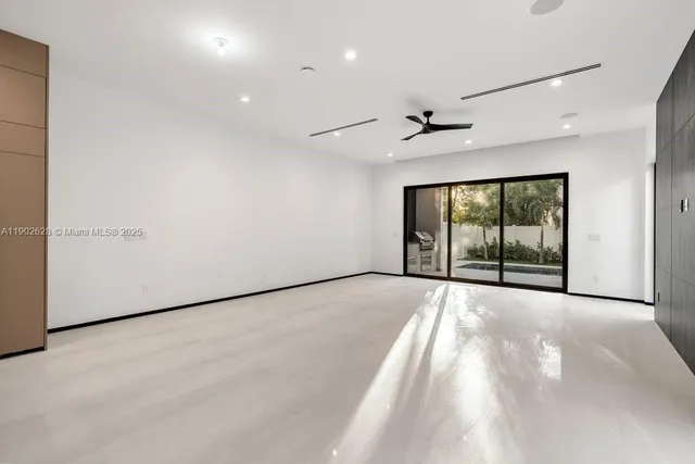 a kitchen with a sink a stove a refrigerator and white cabinets next to a window
