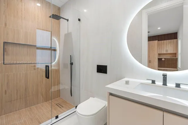 a kitchen with stainless steel appliances kitchen island granite countertop a stove and a microwave