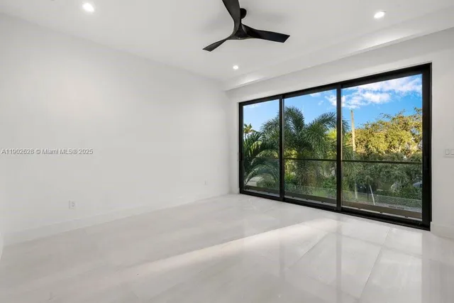 a kitchen with stainless steel appliances a kitchen island a refrigerator and a microwave