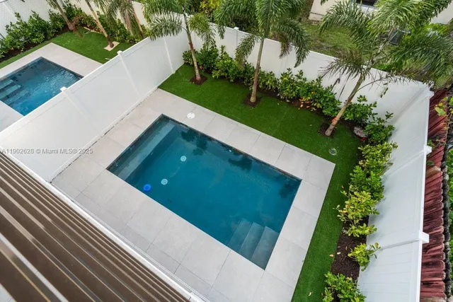 a view of a kitchen with a sink and a refrigerator