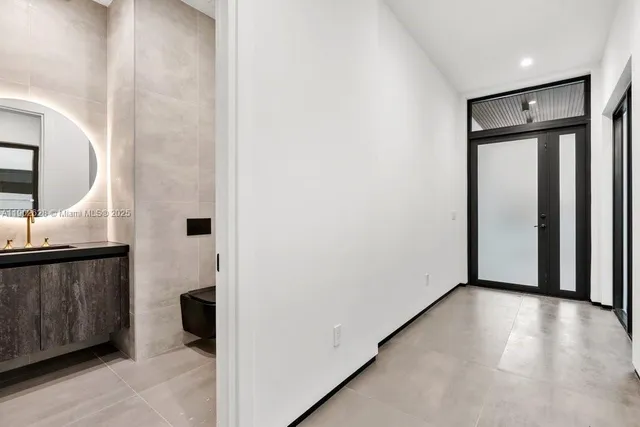 an empty room with an entryway and hallway