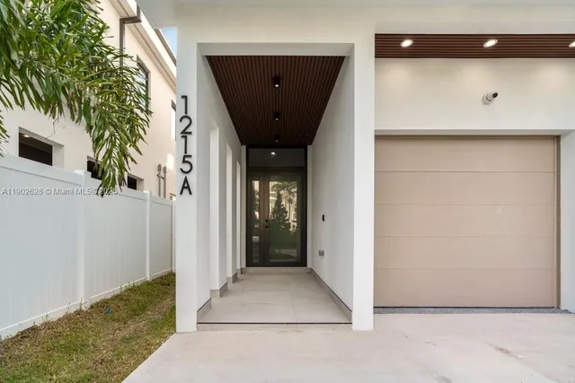 a view of a hallway with wooden door
