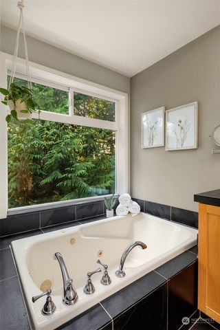 a bath tub sitting in a bathroom next to a window