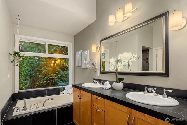 a bathroom with a double vanity sink and mirror