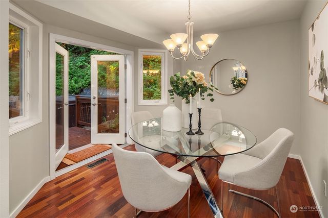 a view of a dining room with furniture wooden floor and chandelier