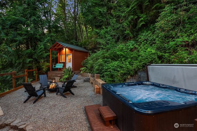 a backyard of a house with yard and outdoor seating