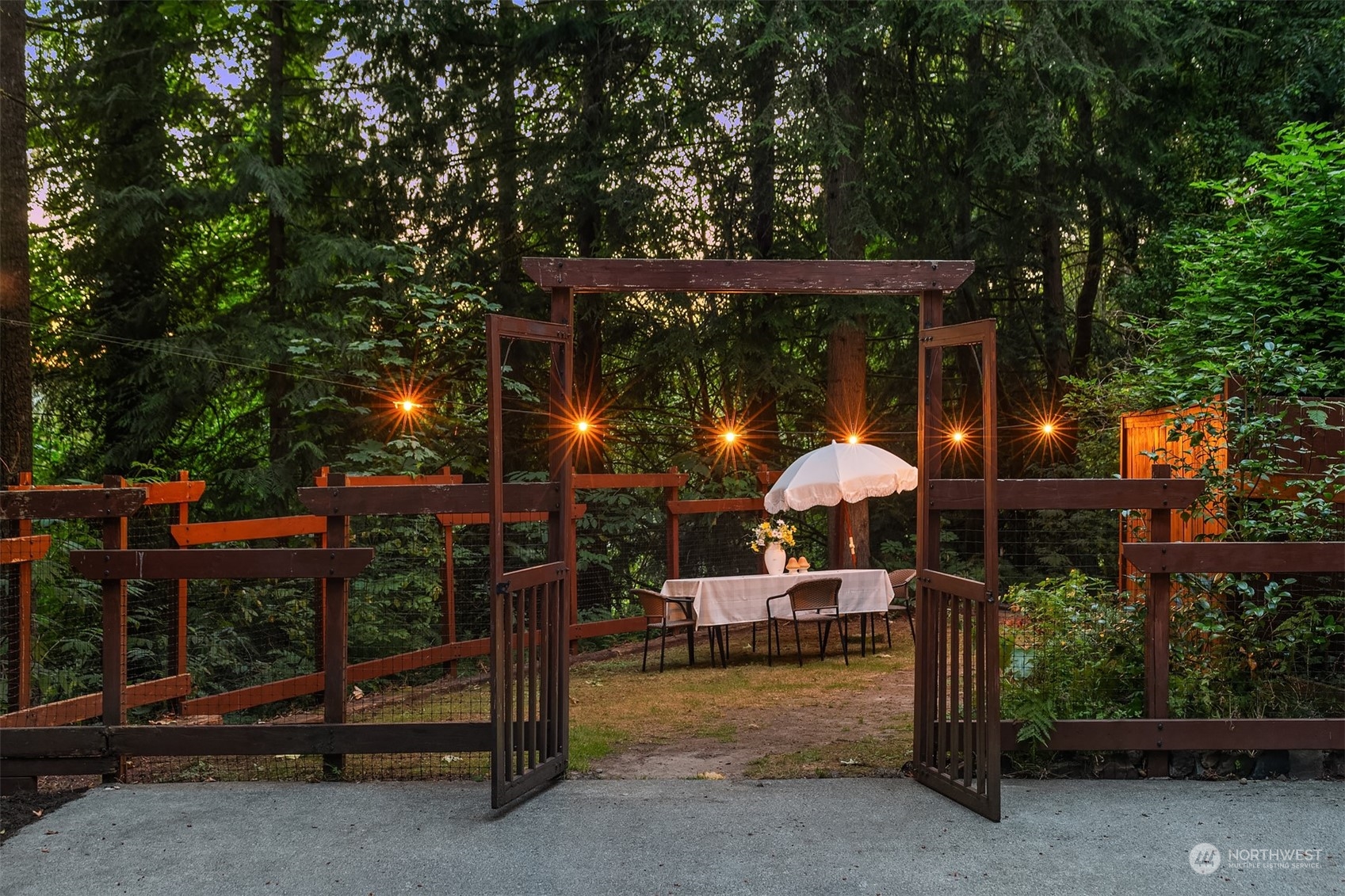730 Redmond-Fall City Road Northeast Carnation, WA 98014 - Photo 37 of 40 a view of a patio with a table and chairs under an umbrella