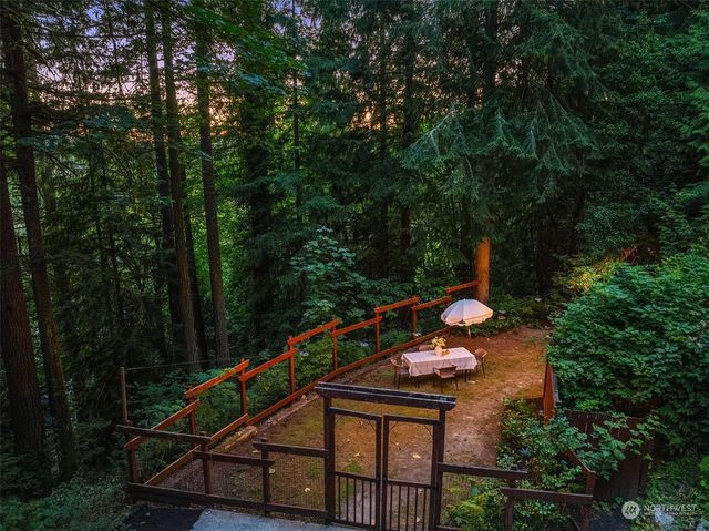 a backyard of a house with wooden floor and outdoor seating