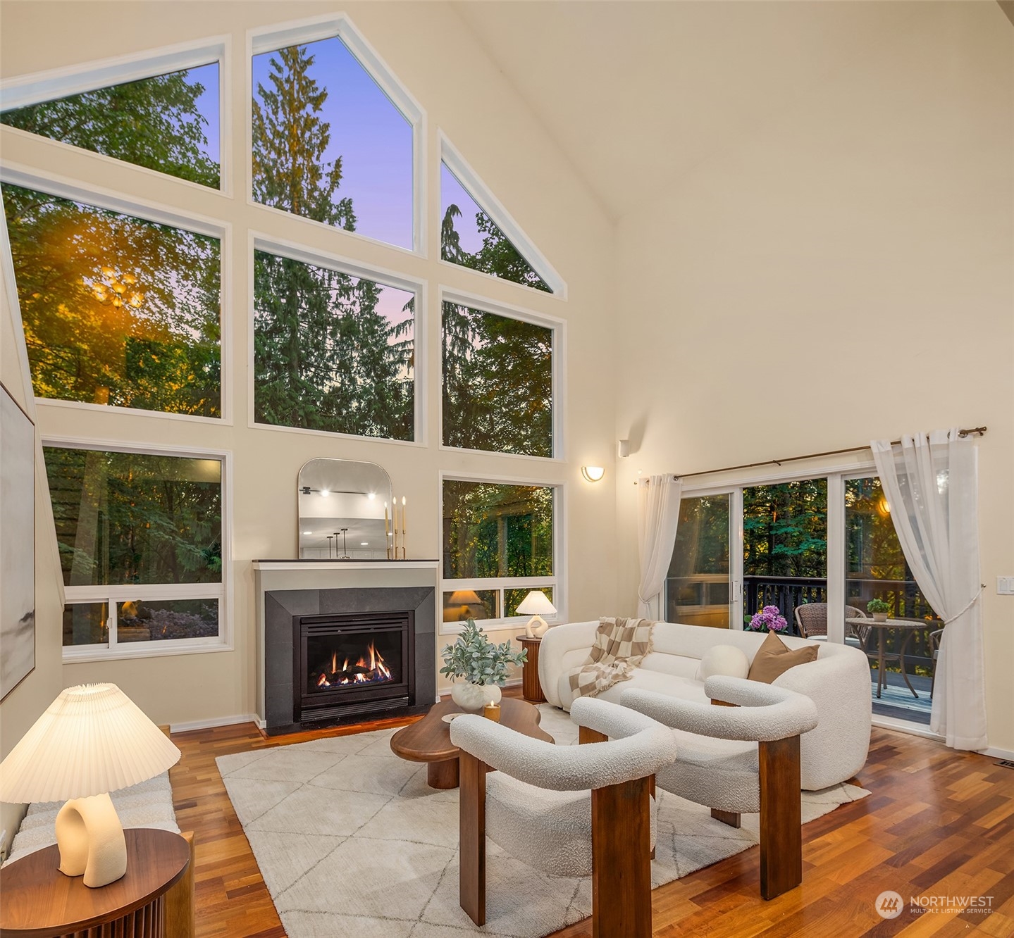 730 Redmond-Fall City Road Northeast Carnation, WA 98014 - Photo 9 of 40 a living room with furniture a fireplace and floor to ceiling windows