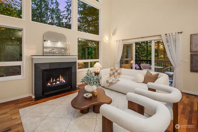 a living room with furniture a fireplace and a large window