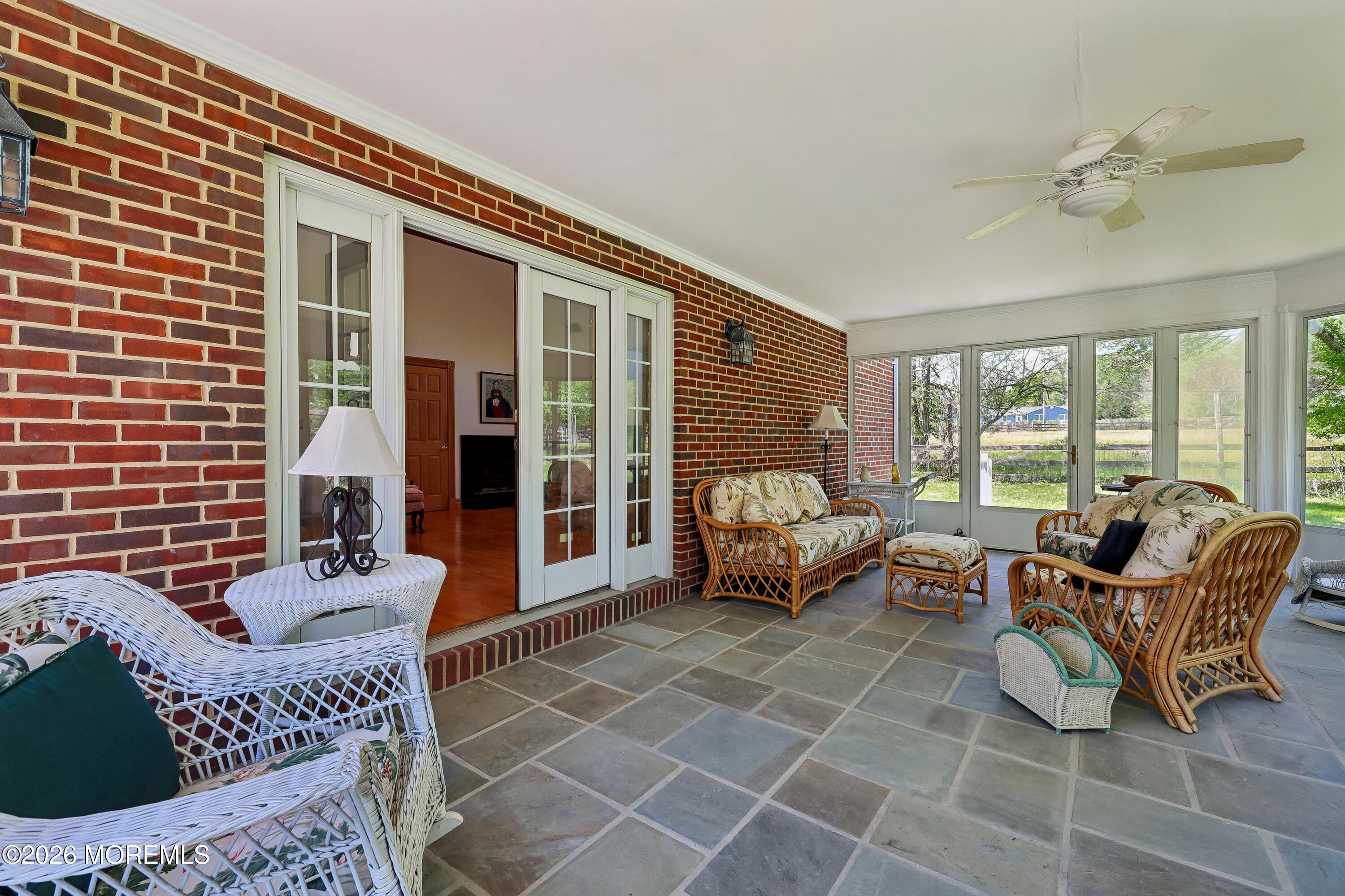 187 Hockhockson Road Colts Neck, NJ 07722 - Photo 37 of 55 a living room with furniture and large windows