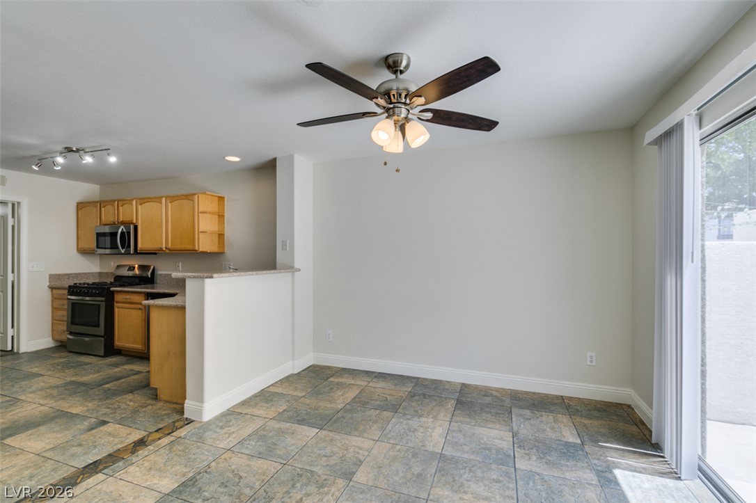 200 Luninborg Street Henderson, NV 89074 - Photo 14 of 40 Functional kitchen with sleek appliances and a seamless flow into a naturally illuminated living space.