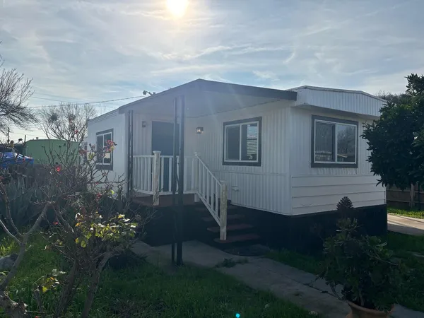 a view of a house with a yard and garden