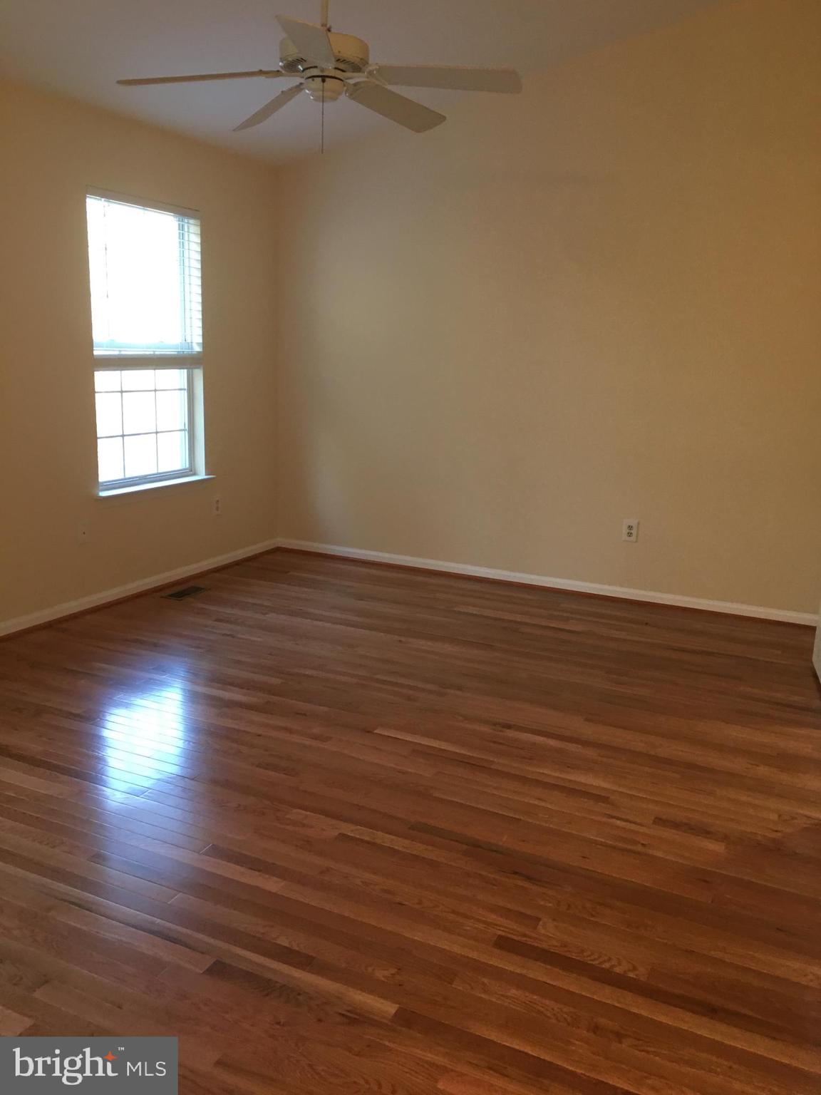6159 Good Hunters Ride Columbia, MD 21045 - Photo 15 of 28 an empty room with wooden floor and windows