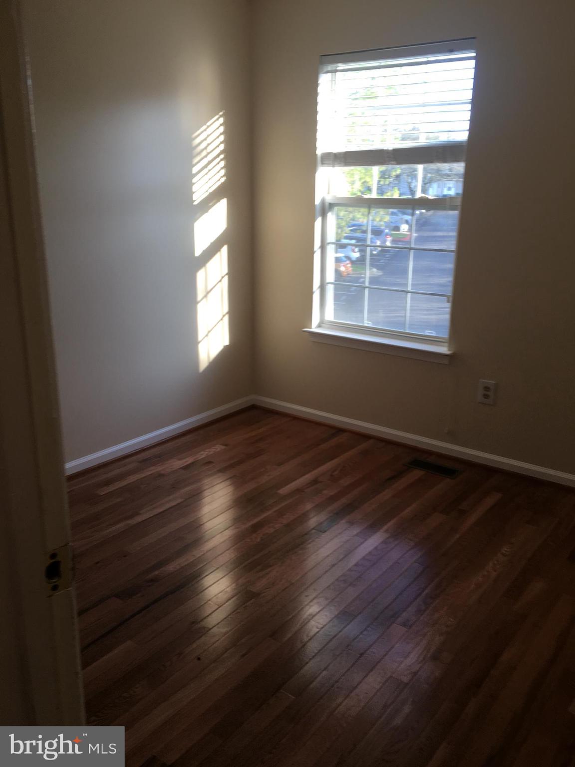6159 Good Hunters Ride Columbia, MD 21045 - Photo 18 of 28 a view of an empty room with wooden floor and a window