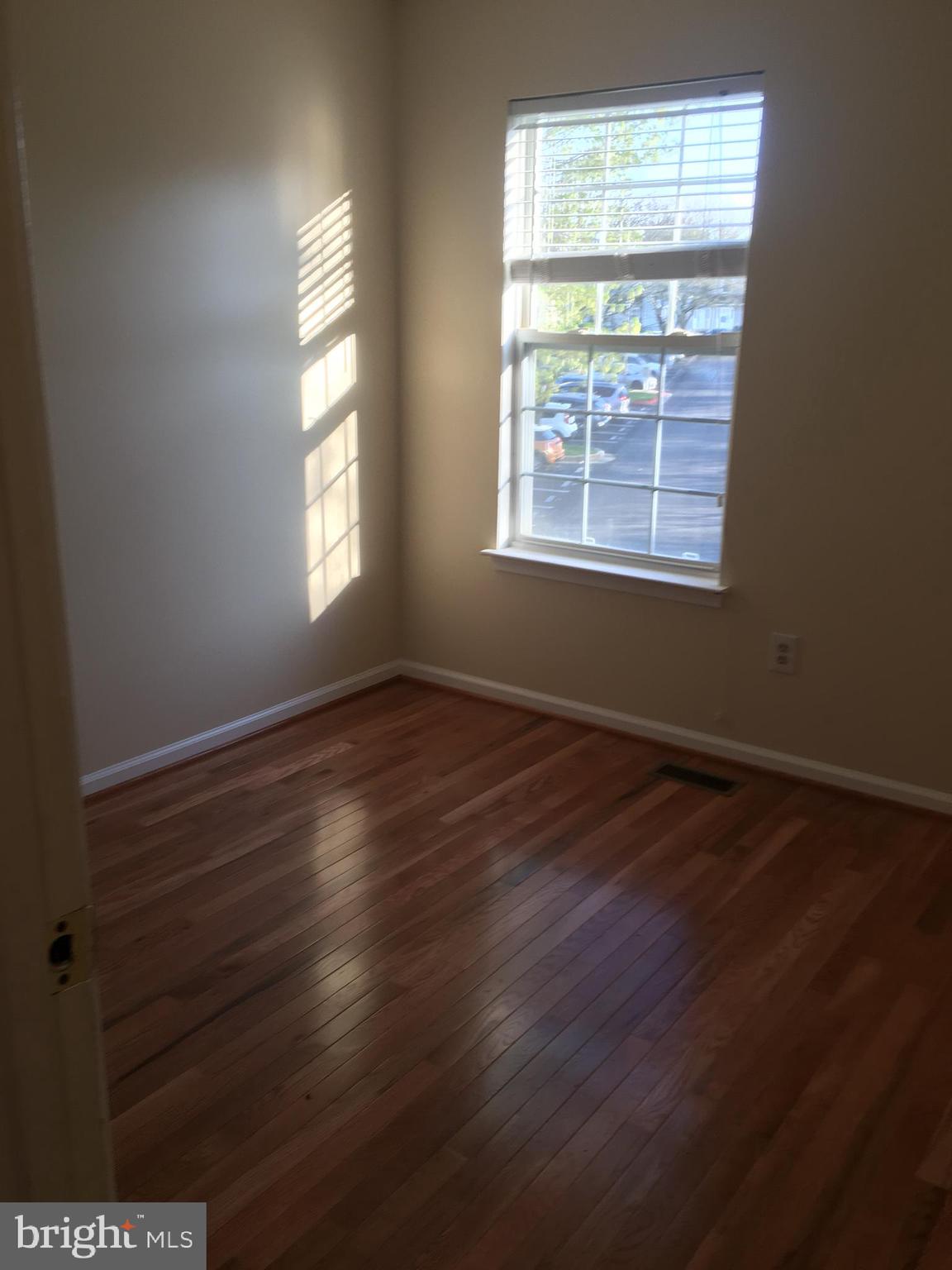 6159 Good Hunters Ride Columbia, MD 21045 - Photo 19 of 28 a view of an empty room with wooden floor and a window